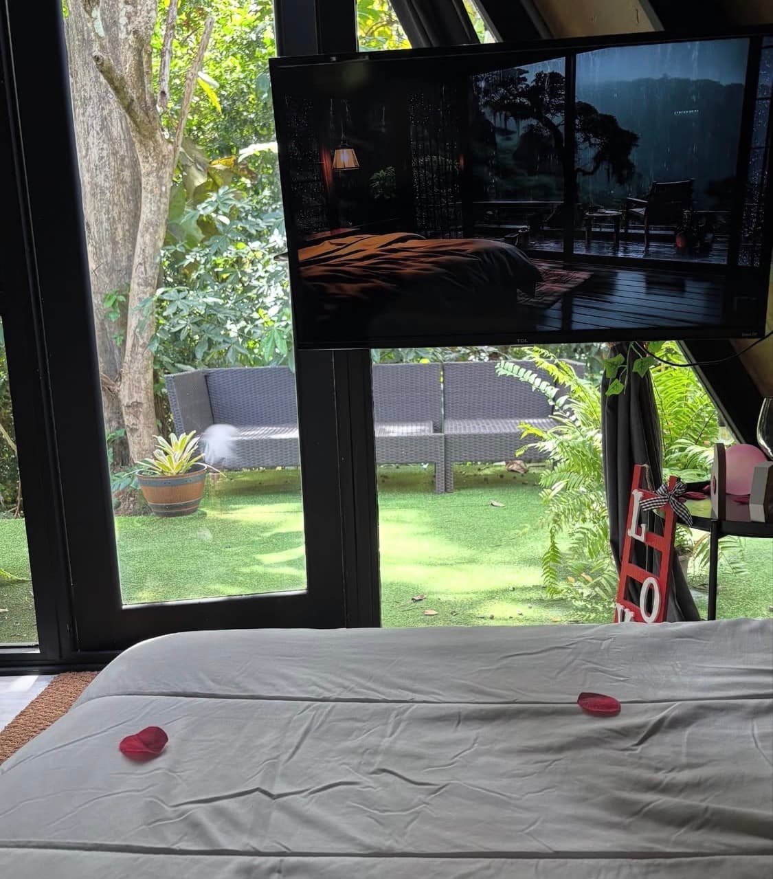 Inside the cabin, with a bed facing the garden